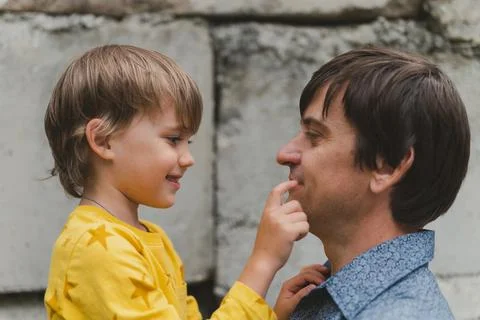 Man dad having quality time with their kid son boy six year old on arms. happ Stock Photos