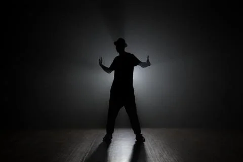 Man dancer posing in the dark and smoke Stock Photos