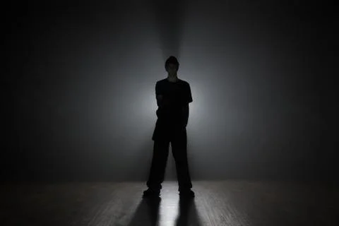 Man dancer posing in the dark and smoke Stock Photos
