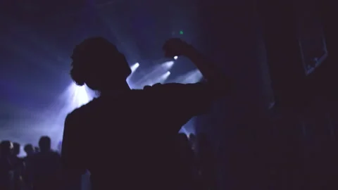 A man dances and enters the crowd of a music concert Stock Footage 237637560