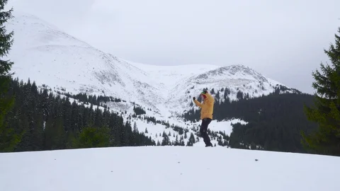 A man dances in the mountains in winter Stock Footage 128107260