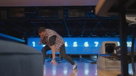 A man dances a victory dance in a bowling club. Celebrating by doing a Stock Footage 168230791