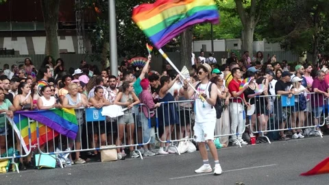 A man dances while waving a rainbow flag during the Madrid Pride Parade (MADO) Stock Footage 339205253
