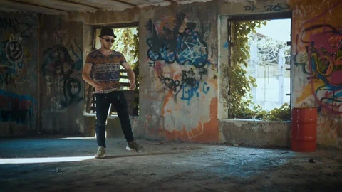 Man dancing in abandoned building with graffiti Stock Footage 117918481
