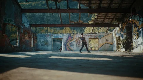 Man dancing in abandoned building with no roof 스톡 동영상 117918443