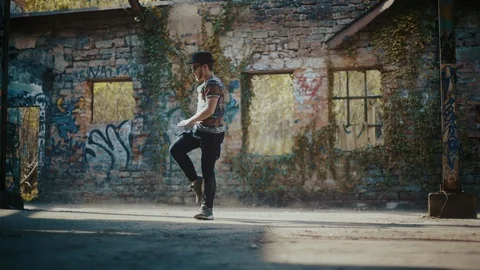 Man dancing in abandoned building while wind blows dust away Video stock 117917238
