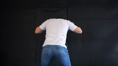 Man dancing against soundproof wall Video stock 307739014