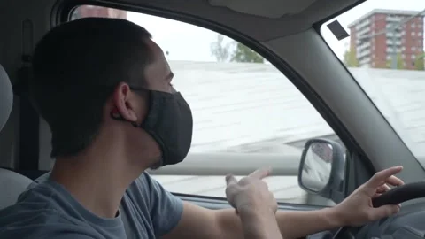 Man dancing and driving car with facial mask. Video stock 143538559