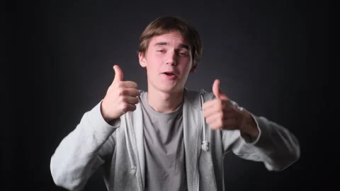 Man Dancing and Giving Thumbs Up on black Background Stock Footage 257472159