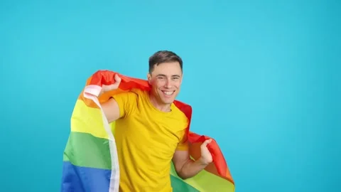 Man dancing and laughing waving a lgbt rainbow flag Stock-Footage 244086575