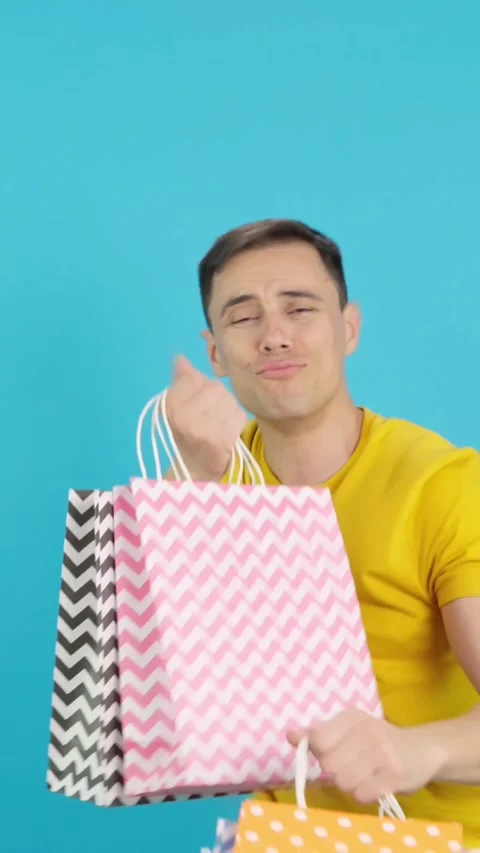 Man dancing and smiling with shopping bags Video stock 257297426