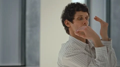 Man dancing with arm movements and hand gestures in a studio setting with Stock Footage 345248850