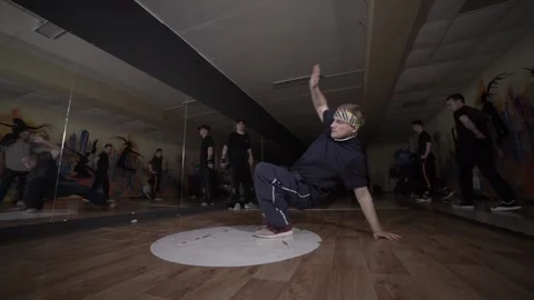 Man dancing break dance in the hall with mirrors. Dancing school. Slow motion Stock Footage 131879251