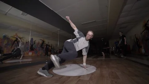 Man dancing break dance in the hall with mirrors. Dancing school. Slow motion Stock Footage 131879266