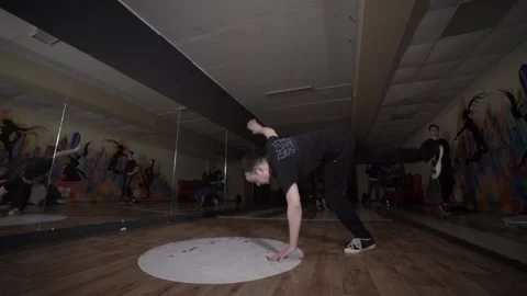 Man dancing break dance in the hall with mirrors. Dancing school. Slow motion Stock Footage 131879271