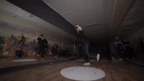 Man dancing break dance in the hall with mirrors. Dancing school. Slow motion Stock Footage 131879297