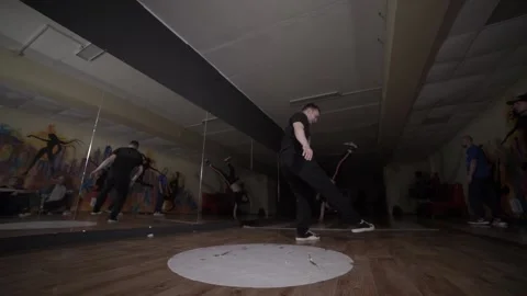 Man dancing break dance in the hall with mirrors. Dancing school. Slow motion Stock Footage 131879301