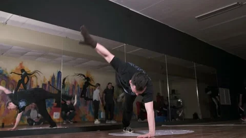 Man dancing break dance in the hall with mirrors. Dancing school. Slow motion Stock Footage 131883615