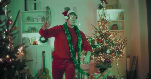 Man dancing at decorated home during Christmas Video stock 259393131