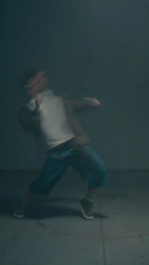 Man Dancing Dynamically in Strobing Lighting with Motion Blur Vertical Stock Footage 335686736