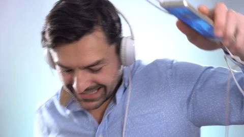 Man dancing with earphones on, cut out Dancing happy and cheerful, smiling Stock-Footage 101652133