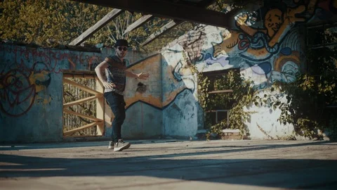 Man dancing in empty building with no roof 스톡 동영상 117917892