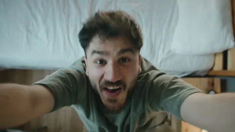 Man dancing energetically in bedroom looking at camera, funny morning mood Stock Footage 344105788