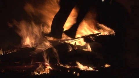 Man dancing on the fire at the flour wars, Galaxidi, Greece Stock Footage 87619653