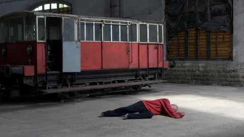 Man Dancing on floor in an old train factory Stock Footage 104464017