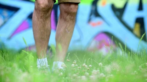 Man dancing in front of graffiti wall Stock Footage 109622244
