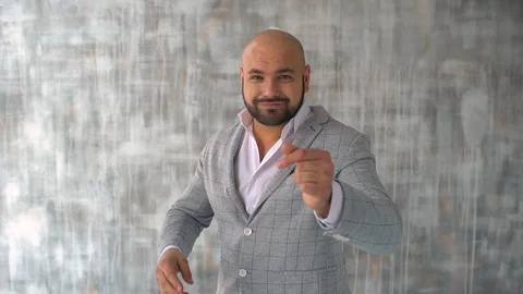 Man dancing on gray background. Crazy happy businessman dancing wearing a suit Stock Footage 86826025