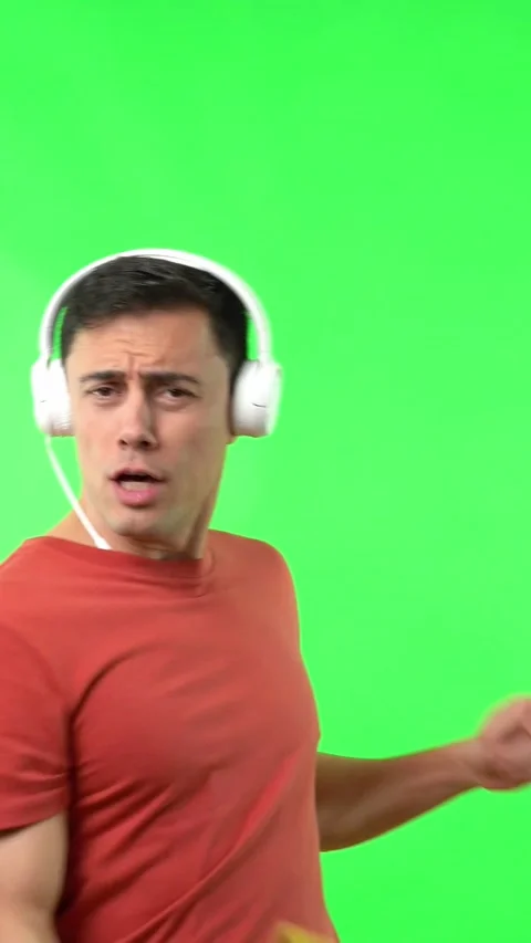 Man dancing happily while listening to music from headphones Stock Footage 242338049