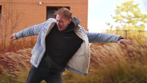 A man dancing hip-hop against the background of a kerpic building Stock Footage 164914965