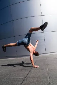Man dancing hip hop using handstand on street Stock Photos