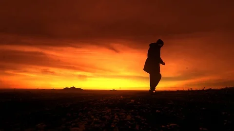 Man dancing in the mountains at sunset Stock Footage 102613892