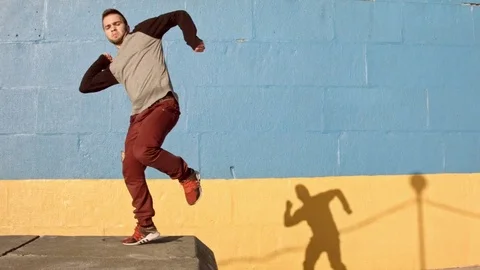 Man dancing in near the wall at dawn. Stock Footage 79728880