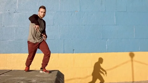 Man dancing in near the wall at dawn. Stock Footage 79732073