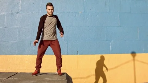 Man dancing in near the wall at dawn. Stock-Footage 79735625