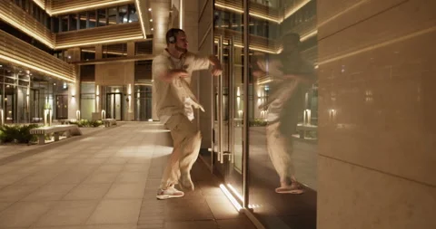 Man dancing near window in night city Stock Footage 244475442
