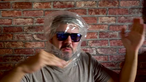 Man dancing with a package on his head 4K Stock Footage 160119641