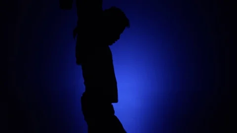 Man dancing silhouette blue background slomo 1 Stock Footage 90782054