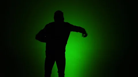 Man dancing silhouette green background slomo 2 Stock Footage 90792549