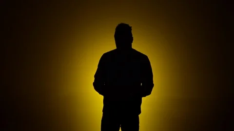 Man dancing silhouette yellow background slomo 1 Stock Footage 90794703