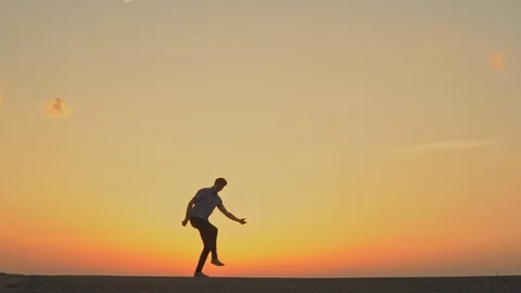 A man is dancing at sunset. slow motion Stock Footage 89383827