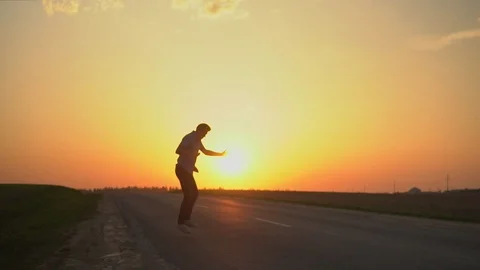 A man is dancing at sunset. slow motion Stock Footage 89384027