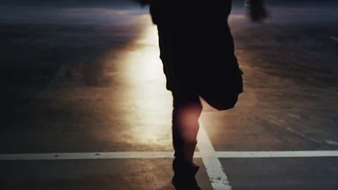 Man dancing in an underground parking lot at night Видео 332535977