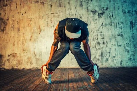 Man dancing on wall background Stock Photos