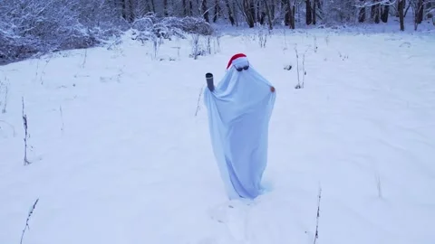 Man dancing wearing ghost costume with sunglasses and Santa's hat in winter Video stock 293259551