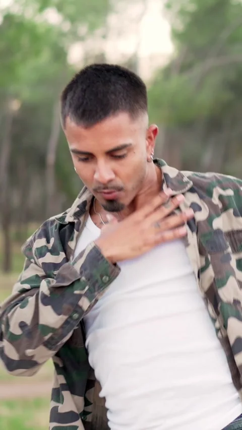 Man dancing while facing the camera in a park Stock Footage 241748552