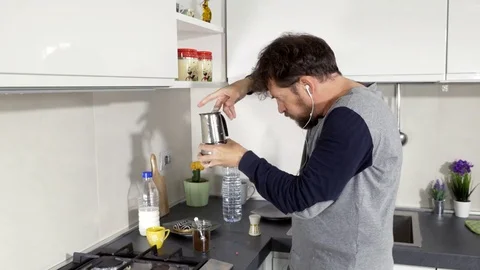 Man dancing while preparing coffee in kitchen in pajamas happy closeup Stock Footage 74977394